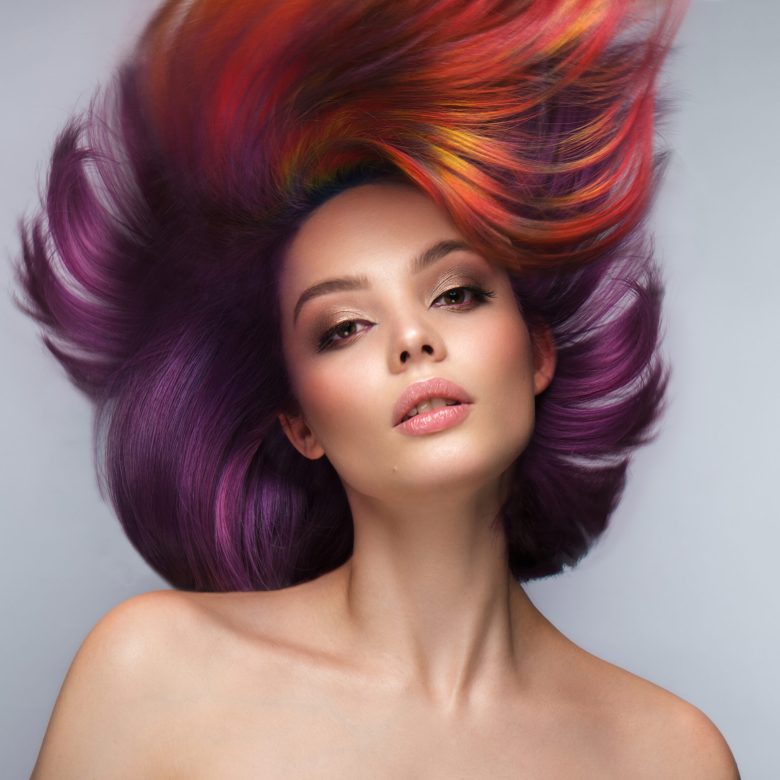 Beautiful woman with multi-colored hair and creative make up and hairstyle. Beauty face.